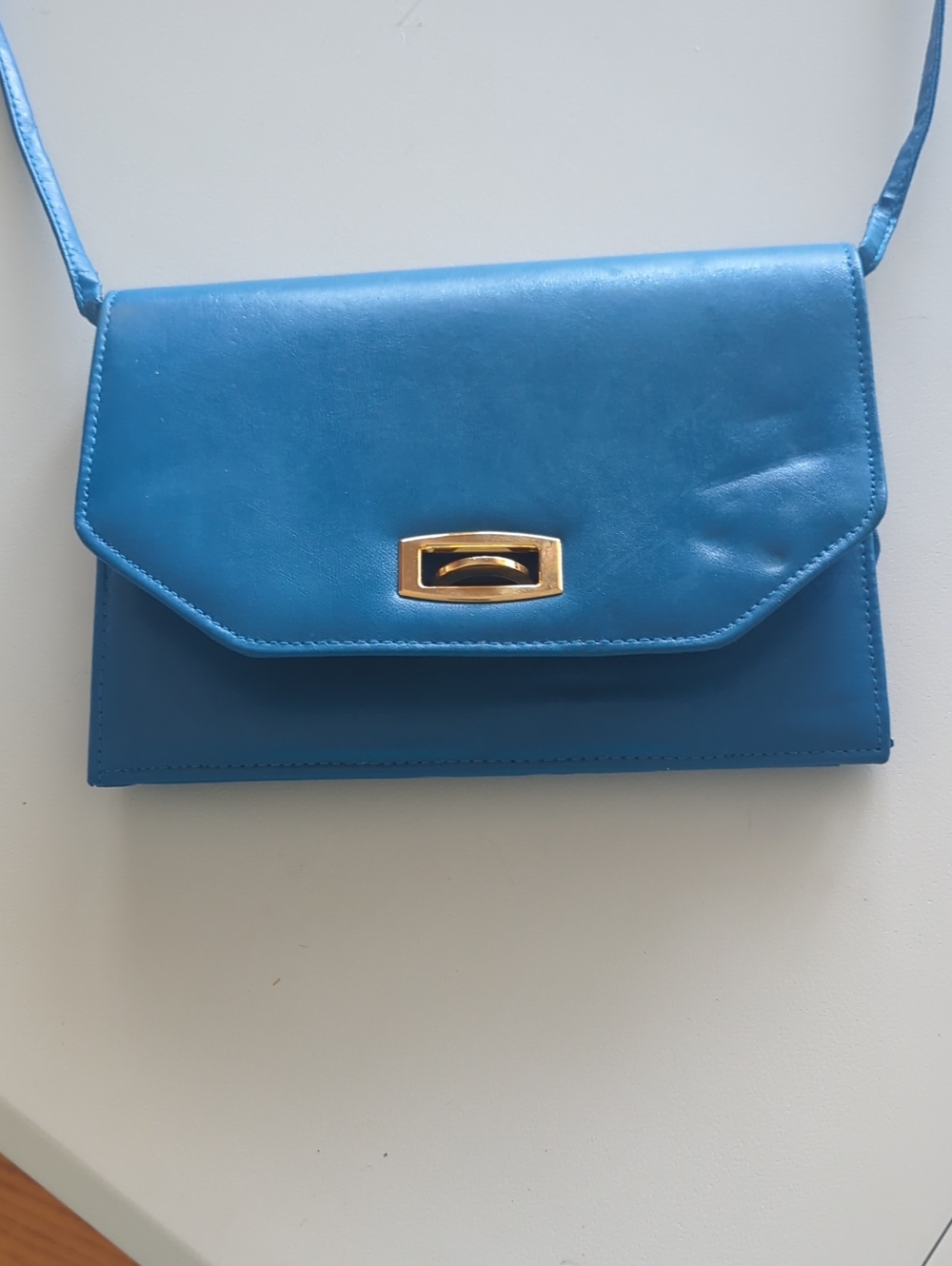 Sleek Blue Crossbody Bag with Gold Accent